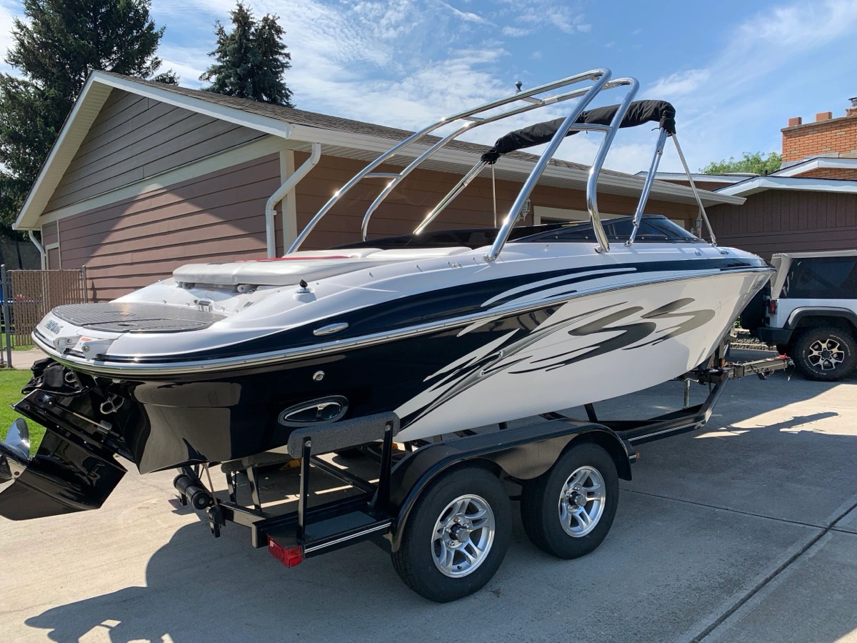 Bowrider boat on its trailer, washed and detailed in a driveway by Miner Details