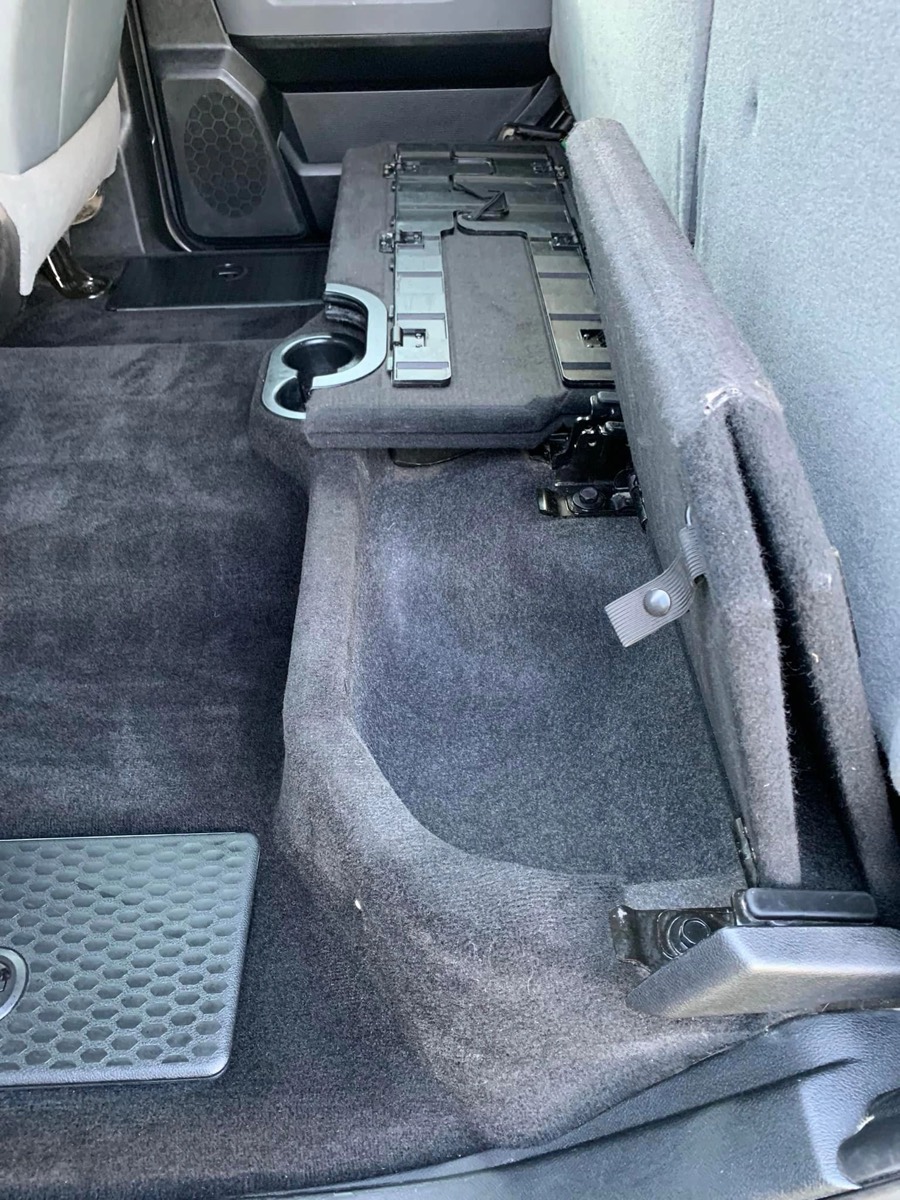 Shampooed rear carpet under the folded seat of a pickup truck